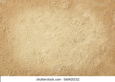 Top view of sandy beach. Background with copy space and visible sand texture. - Shutterstock ID 560420152
