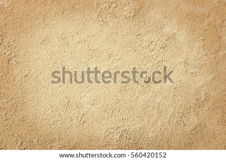 Top view of sandy beach. Background with copy space and visible sand texture.