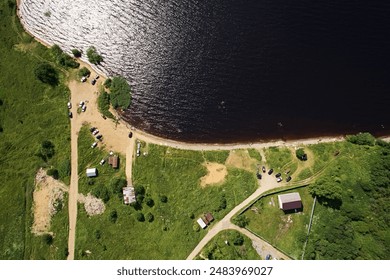 Top view of the sandy beach with people bathing in the lake on a bright sunny day. Aerial photo of landscape - Powered by Shutterstock