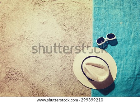 Top view of sandy beach with summer accessories and copy space