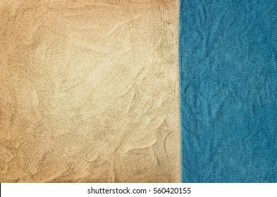 Top view of sandy beach with towel frame. Background with copy space and visible sand texture.