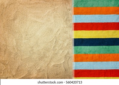 Top View Of Sandy Beach With Towel Frame. Background With Copy Space And Visible Sand Texture.