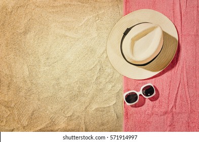 Top view of sandy beach with towel frame and summer accessories. Background with copy space and visible sand texture. Right border made of towel - Shutterstock ID 571914997
