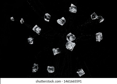 top view of scattered transparent refreshing ice cubes isolated on black