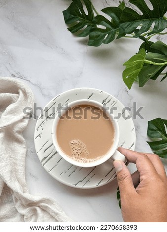 Top view scene of holding milk tea cup to drink, women hand in action