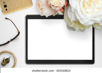 Top view scene with tablet device, jewelry and bouquet of peonies. Styled stock photography. Digital product mock-up.