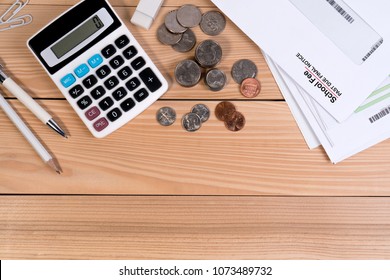 Top View, School Fee Past Due Final Notice Letter, Education Fee, Calculator, Money Coin, Pen And Pencil On Wooden Table. School Due Date Concept.