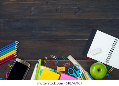 Top view of School Supplies on a wooden table with space for text - Powered by Shutterstock