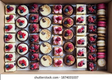 Top View Of Selection Of Colorful And Delicious Cake Desserts In Box.