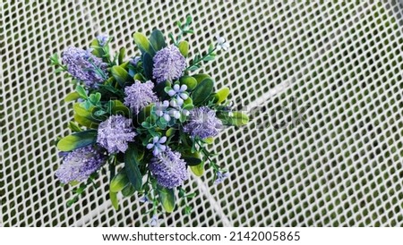 Top view Selective focus on  fake purple flower in vase decorative interior design                          