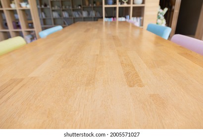 Top View And Selective Focus With Perspective View Of Long Wooden Table With Colorful Chairs And Design In Relaxing Atmosphere For Business, Working Or Meeting In Shows Beautiful For Background.