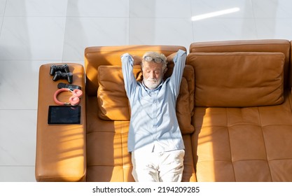 Top view of senior elderly man laying on sofa at home - Powered by Shutterstock