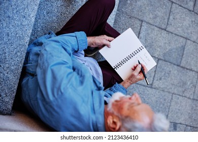 Top View Of A Senior Man Sitting Outside And Writing To Do List.