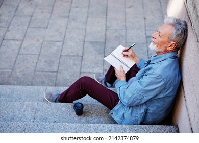 Top View Of A Senior Man Sitting Outside And Writing To Do List.