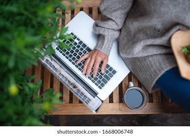 Top View Of Senior Woman With Laptop Sitting Outdoors On Terrace, Working.