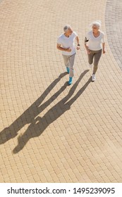 Top View Of Senior Woman And Man Running Doing Fitness Exercises Outdoors