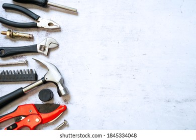 Top view of Set of construction and maintenance tooling for handyman on white concrete background with copy space