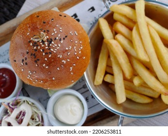 Top View, Set Of Hamburger, Salad And French Fries (fried Potato) With Two Dipping Sauce, Fast Food Serving On Printed Wax Paper. Blur Background, Selective Focus