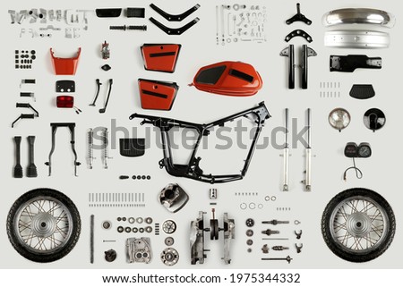 Top view of a set of motorcycle parts. Disassembled motorcycle on a light background