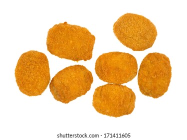 Top View Of Several Cooked Breaded Chicken Nuggets On A White Background.