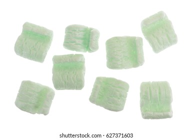 Top View Of Several Green Polystyrene Packing Peanuts Isolated On A White Background.