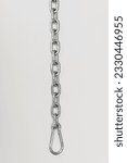 Top view of shiny metallic chain with metal rings and carabiner placed on white background