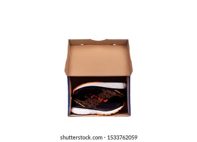 Top View Of  Shoe Box Isolated On White Background. Black Pair Of Shoes Inside Shoe Box.