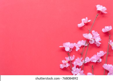 Top View Shot Of Arrangement Decoration Chinese New Year & Lunar Festival Concept Background.Beautiful Pink Plum Flower And On Modern Red Wood Backdrop At Home Office Desk Studio.free Space For Design