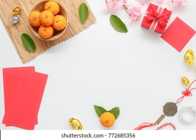 Top View Shot Of Arrangement Decoration Chinese New Year & Lunar Festival Concept Background.Orange & Tea Pot Also Red Pocket Money With Map To Travel.Variety Object On Modern Brown Wood At Home Desk.