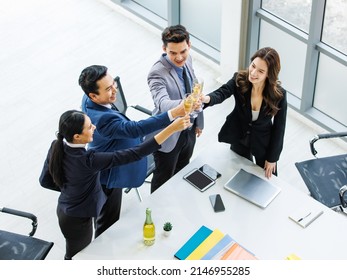 Top view shot Asian happy cheerful professional successful businessman and businesswoman in formal business suit standing smiling holding tall champagne glass toasting celebrating cheers together.