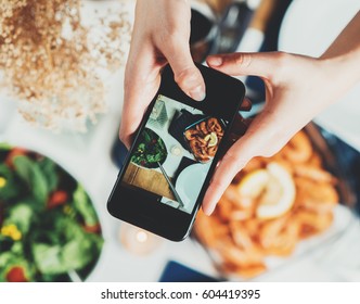 Top View Shot Of Female Hands Taking A Picture Of Food, Young Hipster Girl Making A Photo Of Tasty Mediterranean Food Table