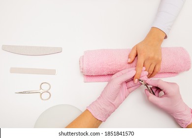 Top View Shot Of A Manicurist Using A Cuticle Clipper To Give A Nail Manicure To Her Client In The Beauty Salon. Master Of Manicure Remove A Cuticle Nail With Nail Clipper.