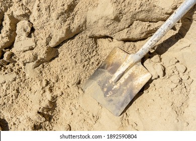 Top View Shovel On Sand In Construction Site