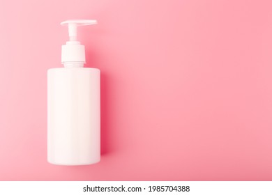 Top view of shower gel or intimate gel for woman in white tube on pink background with copy space