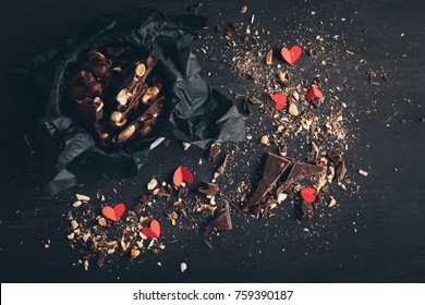 Top View Of Shredded Chocolate With Nuts And Red Paper Hearts