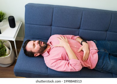 Top View Of A Sick Man With Asthma Lying On The Sofa And Trying To Calm Down To Breathe Better 