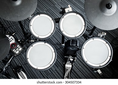 Top View Side Of Electronic Modern Drum Kits Set In A Small Music Room With White Wall