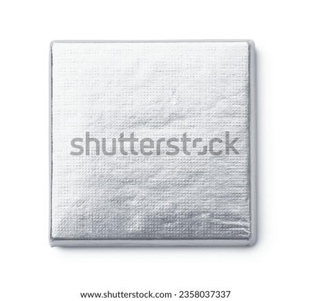 Top view of silver foil wrapped square chocolate bar isolated on white