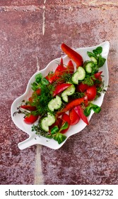 Top view simple salad - sliced red tomatoes and green cucumbers with greenery on white plate, background, restaurant menu concept. Vegetarian, summer food, healthy lifestyle. - Shutterstock ID 1091432732