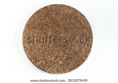Top view of a simplistic brown circular hot pad mat crafted from sustainable cork material.
