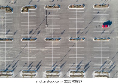top view of a single car in a mostly empty parking lot