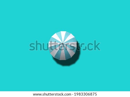 Top view, Single white and cyan umbrella isolated on cyan background, stock photo, invesment, business, summer concept