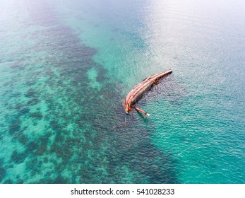 Top View Of Sink Boat In Ocean With Clear Water.