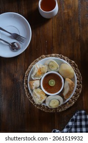 Top View Of Siomay Or Somai On A White Plate, Is An Indonesian Steamed Fish Dumpling With Vegetables Served In Peanut Sauce.  It Is Derived From Chinese Shumai.