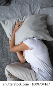 Top View Sleepless Mature Senior Woman Lying On Bed At Home, Depressed Hopeless Middle Aged Female Covering Head With Pillow, Suffering From Insomnia, Lack Of Sleep, Psychological Problem