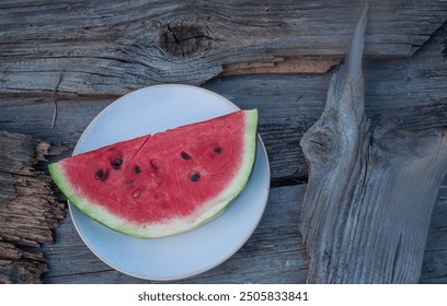 Top view of a slice of watermelon on a wooden background. No people. - Powered by Shutterstock