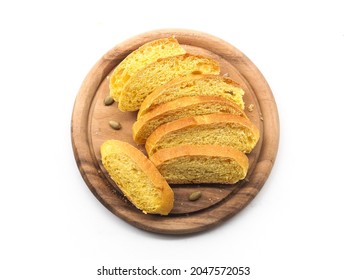 Top View Slice Of Yellow Pumpkin Bread Roll On  Round Wooden Board On White Background