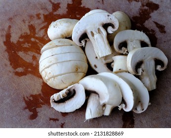 Top View Of Sliced Large White Mushrooms On Cutting Board