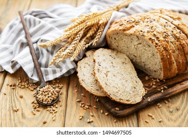 Top view of sliced wholegrain bread on a wooden table