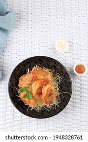 Top View Slices Of Chicken Egg Rolls, Is Omelete Egg Stuffed With Ground Chicken And Spices, Steamed And Deep Fry, Served With Chili Mayonaise Sauce Above Crispy Vermicelli